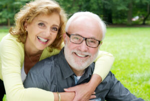 happy older couple smiling and showing affection